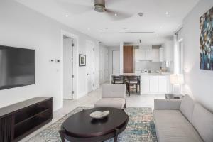 a living room with a couch and a table at One bedroom condo at ONE Cable Beach in Nassau