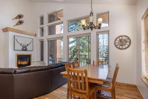 a living room with a table and a couch at Alpenglow Ski n Ski Out with Amazing Views in Durango Mountain Resort