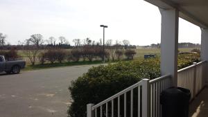 a porch of a house with a truck parked on the street at Shore Stay Suites in Cape Charles
