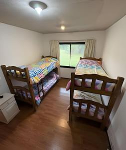 a bedroom with two bunk beds and a window at Hermosa Mansión c/pileta y jacuzzi -Barrio privado in Bajo Lunlunta +13 photos