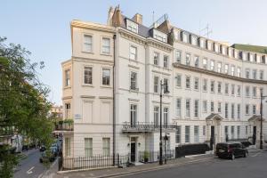 a large white building on a city street at Charles of Mayfair in London