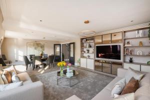 a living room with a couch and a table at Charles of Mayfair in London