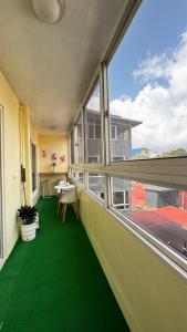 a room with green flooring and a large window at WPY Condotel in Baguio