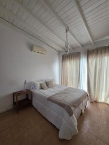 a bedroom with a large bed and a window at La madrugada in La Lonja