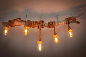 a wooden branch chandelier with lights on it at Skiathos Pearl in Skiathos +28 photos