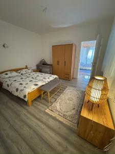 a bedroom with a bed and a table and a lamp at Resting House Oaza in Bihać