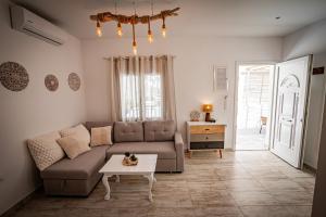 a living room with a couch and a table at Skiathos Pearl in Skiathos Town