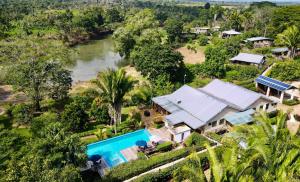 an aerial view of a house and a river at Dream Valley Belize in Teakettle Village