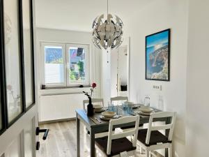 a dining room with a table and a chandelier at St Mountain Escape in Žirovnica