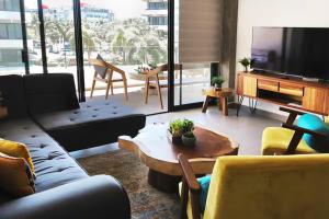 a living room with a couch and a table at Puertarena in Nuevo Vallarta