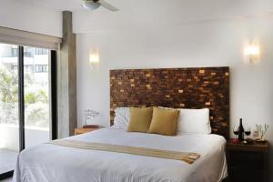a bedroom with a large bed with a brick wall at Puertarena in Nuevo Vallarta +147 photos