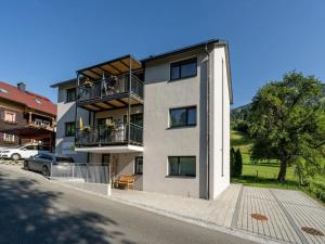 an apartment building with balconies on a street at Le Soleil in Bruck an der Großglocknerstraße