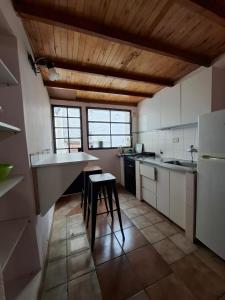 a kitchen with a counter and a stool in it at Patagonia's Faro Norte Lighthouse in Patagones
