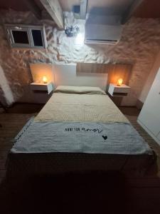 a bedroom with a large bed with two lights on it at Patagonia's Faro Norte Lighthouse in Patagones +7 photos