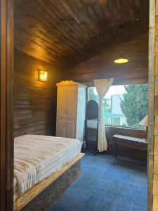 a bedroom with a bed and a window at Nhà Của Sen in Da Thien