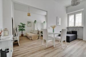 a white living room with a table and chairs at Oasis Suite - Subway 50 meters just 5 minutes from Duomo in Milan