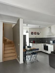 a kitchen and dining room with a table and chairs at Mazet de Jade in Vallon-Pont-dʼArc