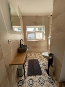 a small bathroom with a sink and a tub at geräumige Wohnung mit Terrasse in Halle Westfalen +28 photos