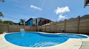 a large blue swimming pool in front of a fence at Legoon View in Tortuguero
