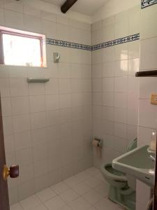 a bathroom with a toilet and a sink at Finca en Barbosa Descanso Naturaleza y Desconexion in Barbosa +5 photos