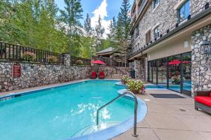 a swimming pool in front of a building at Luxury 3 Bedroom Condo In The Heart Of Beaver Creek Village With Heated Pool in Beaver Creek