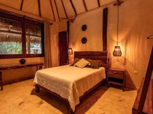 a bedroom with a bed and a window at Kasa UhMay Tulum in Francisco Uh May +108 photos