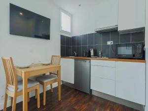a kitchen with a small table and a microwave at Charming studio - 2P- Parc Monceau in Paris