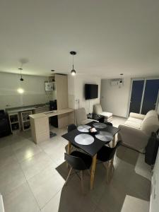 a kitchen and living room with a table and chairs at Alojamientosvillamaria in Villa María