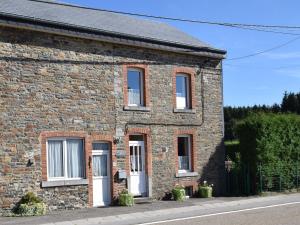 a brick house with white doors and windows at Chalet in Bovigny with Forest & BBQ in Bovigny