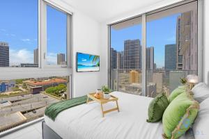 a bedroom with a large window with a view of the city at Beautiful 2BR Apartment with gym and Pool in Miami