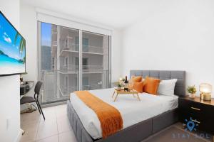 a bedroom with a large bed and a large window at Beautiful 2BR Apartment with gym and Pool in Miami +30 photos