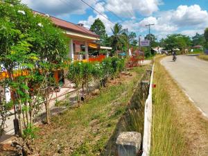 a person riding a motorcycle down a road next to trees at Aunora Standard Room in San Miguel