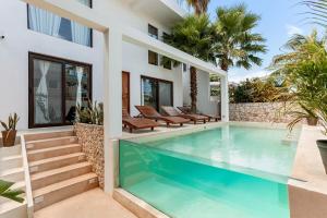 a swimming pool in the backyard of a house at Villa Jungle, Isla Mujeres in Isla Mujeres