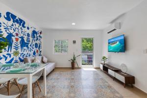 a living room with a couch and a table at Villa Jungle, Isla Mujeres in Isla Mujeres