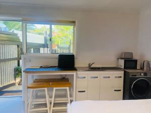 a kitchen with a desk with a laptop on it at Bird Paradise In Bush setting in Bendigo