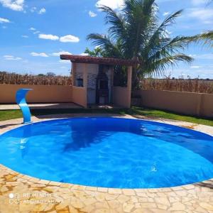 Chapadacasa irece a 30 km de jussara的房子前面的一个蓝色大游泳池