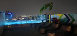 a swimming pool on the roof of a building at night at Studio na Árvore no Centro do Rio in Rio de Janeiro