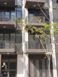 an external view of an apartment building with balconies at madintay b8 modern cozy studio in Madinaty