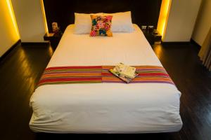 A bed or beds in a room at Wakapunku Boutique Hotel