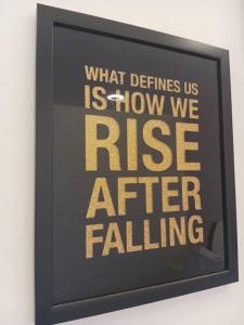 a sign that says what defines us is how we rise after falling at Elsa Tawau homestay near Airport in Tawau
