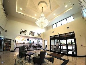 a large lobby with a chandelier and tables and chairs at Comfort Suites Westchase Houston Energy Corridor in Houston