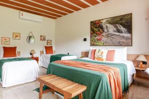 a bedroom with two beds and a waterfall painting on the wall at Flat Natureza Hotel Fazenda Pedra do Rodeadouro Bonito PE in Bonito +70 photos