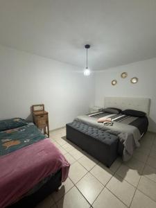 a bedroom with a bed and a table in it at Alojamiento CENTRICO in Villa María