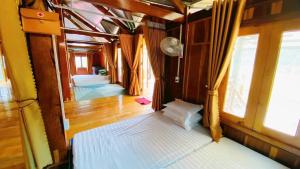 a room with a bed in a train with windows at Cô gái thái Homestay in Mù Cang Chải