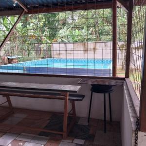 a view of a swimming pool through a window at Cabaña Gerya in Chachagua