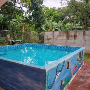 a swimming pool with a painting on it at Cabaña Gerya in Chachagua