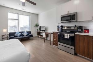 a kitchen and living room with a stove top oven at Charming Nulu SDO CozySuites 01 in Louisville