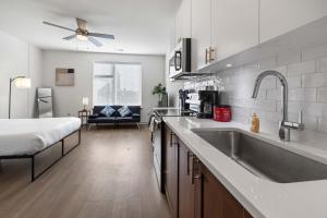 a kitchen with a sink and a bed in a room at Charming Nulu SDO CozySuites 01 in Louisville +22 photos