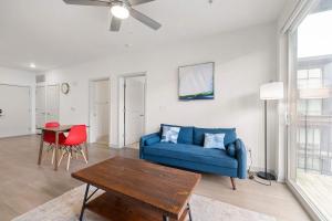 a living room with a blue couch and a table at Stunning Nulu 1BR CozySuites 09 in Louisville