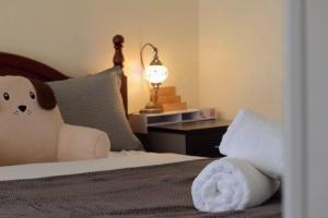 a bedroom with a bed with a stuffed animal on it at Coleman Comfort Hub - close to City&Air port in Moonah